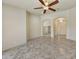 Open-concept living space featuring tile floors, arched doorways, and modern ceiling fan at 7332 W Pershing Ave, Peoria, AZ 85381