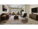 Bright living room with neutral tones, tile flooring, stylish furniture and a ceiling fan for added comfort at 7332 W Pershing Ave, Peoria, AZ 85381