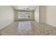 Spacious room with neutral tile flooring, ceiling fan, and views of the backyard pool at 7332 W Pershing Ave, Peoria, AZ 85381