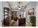 Well-lit home office features a rustic industrial design, custom shelving and a comfortable work space at 7332 W Pershing Ave, Peoria, AZ 85381