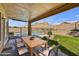 Covered patio offers an outdoor dining area with views of the pool and manicured backyard space at 7332 W Pershing Ave, Peoria, AZ 85381