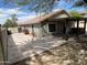 View of backyard's extended covered patio with pavers and low maintenance desert landscaping at 7415 S 16Th S Dr, Phoenix, AZ 85041