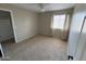 Bright bedroom with a ceiling fan, window, and neutral-toned walls and carpet at 7415 S 16Th S Dr, Phoenix, AZ 85041