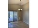 Dining area with tile flooring, slider to the patio, and elegant chandelier lighting at 7415 S 16Th S Dr, Phoenix, AZ 85041