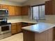 Well-equipped kitchen with stainless steel appliances, light countertops, and ample cabinet space at 7415 S 16Th S Dr, Phoenix, AZ 85041