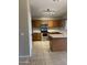 Spacious kitchen with stainless steel appliances, tiled flooring, and oak cabinetry at 7415 S 16Th S Dr, Phoenix, AZ 85041