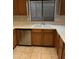 Stainless steel dishwasher next to sink with wood cabinets at 7415 S 16Th S Dr, Phoenix, AZ 85041