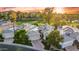 Beautiful aerial view of a neighborhood bordering a golf course with mature trees at 7425 E Gainey Ranch Rd # 13, Scottsdale, AZ 85258