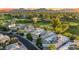 Scenic aerial view showcases homes bordering a golf course with mountain backdrop at 7425 E Gainey Ranch Rd # 13, Scottsdale, AZ 85258
