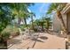 Relaxing backyard patio with lush landscaping, palm trees, and a beautiful view at 7425 E Gainey Ranch Rd # 13, Scottsdale, AZ 85258