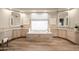 Spacious bathroom with dual vanities, travertine tile, framed mirrors, soaking tub and natural light at 7425 E Gainey Ranch Rd # 13, Scottsdale, AZ 85258