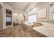 Bright, spacious bathroom featuring dual sinks, soaking tub, glass block window and separate glass shower at 7425 E Gainey Ranch Rd # 13, Scottsdale, AZ 85258