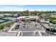 Aerial view of a clubhouse with parking, tennis courts, and pool at 7425 E Gainey Ranch Rd # 13, Scottsdale, AZ 85258