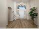 Elegant foyer featuring hardwood floors, shuttered sidelights, a decorative chandelier, and high ceilings at 7425 E Gainey Ranch Rd # 13, Scottsdale, AZ 85258