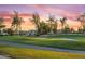 Beautiful view of golf course, mature trees, and purple sunset at 7425 E Gainey Ranch Rd # 13, Scottsdale, AZ 85258