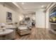 Bright and inviting living room with hardwood floors, a modern bar, and open floor plan at 7425 E Gainey Ranch Rd # 13, Scottsdale, AZ 85258
