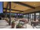 A comfortable outdoor patio offers stylish seating under a wooden ceiling with modern fixtures at 7425 E Gainey Ranch Rd # 13, Scottsdale, AZ 85258