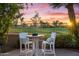 Inviting outdoor seating area with a table and chairs overlooking a scenic golf course at 7425 E Gainey Ranch Rd # 13, Scottsdale, AZ 85258