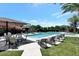 Resort-style pool with lounge chairs, umbrellas, and well-manicured landscaping, perfect for relaxation at 7425 E Gainey Ranch Rd # 13, Scottsdale, AZ 85258