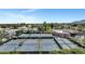 Aerial view of multiple well-maintained tennis courts surrounded by mature trees at 7425 E Gainey Ranch Rd # 13, Scottsdale, AZ 85258