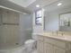 Well-lit bathroom features a spacious, tiled walk-in shower and a vanity with a light marble countertop and a large mirror at 7816 N 47Th St, Paradise Valley, AZ 85253