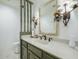 Bathroom features a stone countertop, black fixtures, wall sconces, and decorative doll at 7816 N 47Th St, Paradise Valley, AZ 85253