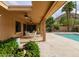 Spacious covered patio with ceiling fans offers stunning views of the pool, mountains, and lush desert landscape for entertaining at 7816 N 47Th St, Paradise Valley, AZ 85253