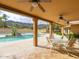 Inviting covered patio with ceiling fans overlooks the refreshing pool and desert landscape, perfect for relaxing and entertaining guests at 7816 N 47Th St, Paradise Valley, AZ 85253