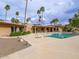 Relaxing backyard with a large swimming pool surrounded by palm trees and desert landscaping, with mountain views in the distance at 7816 N 47Th St, Paradise Valley, AZ 85253