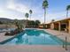 Inviting backyard pool with palm trees offering a relaxing oasis with mountain views at 7816 N 47Th St, Paradise Valley, AZ 85253
