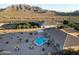 Aerial view of backyard featuring pool, patio, landscaping, and mountain backdrop at 7969 S 172Nd St, Queen Creek, AZ 85142