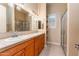 Bathroom features double sinks, a large mirror, tiled countertops and floors, and a glass-enclosed shower at 7969 S 172Nd St, Queen Creek, AZ 85142