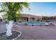 Home exterior featuring landscaped yard with pool and covered patio at 7969 S 172Nd St, Queen Creek, AZ 85142