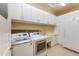 Spacious laundry room featuring white cabinetry, a sink, a washer, and a dryer at 7969 S 172Nd St, Queen Creek, AZ 85142