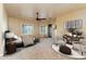 Bright main bedroom features a ceiling fan, sitting area, and an ensuite, providing a private retreat at 7969 S 172Nd St, Queen Creek, AZ 85142