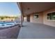Covered patio with view of pool, desert landscape, and double-door entrance at 7969 S 172Nd St, Queen Creek, AZ 85142