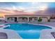 Backyard swimming pool and hot tub against home exterior and sunset sky at 7969 S 172Nd St, Queen Creek, AZ 85142