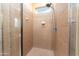 Shower featuring neutral tile and an adjustable shower head and window at 7969 S 172Nd St, Queen Creek, AZ 85142
