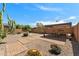 Enjoy the large backyard with desert landscaping, brick-lined concrete and cozy dining area at 799 W Press Rd, San Tan Valley, AZ 85140