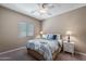 Relaxing bedroom featuring a queen bed, carpet, and lots of natural light at 799 W Press Rd, San Tan Valley, AZ 85140