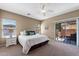 Inviting bedroom with neutral tones, ceiling fan, and sliding glass door to the patio at 799 W Press Rd, San Tan Valley, AZ 85140