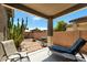 Relaxing covered patio featuring a lounge chair, grill, desert landscaping and brick-lined concrete at 799 W Press Rd, San Tan Valley, AZ 85140