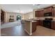 Open-concept kitchen with a breakfast bar that flows into the living room and access to the patio at 799 W Press Rd, San Tan Valley, AZ 85140