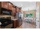 Modern kitchen with granite countertops, stainless steel appliances, and dark wood cabinetry at 799 W Press Rd, San Tan Valley, AZ 85140