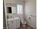 Bright bathroom featuring a updated vanity, mirror, and toilet at 8609 S 16Th St, Phoenix, AZ 85042