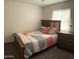 Comfortable bedroom with wood bed frame, carpet, and neutral-colored walls at 8609 S 16Th St, Phoenix, AZ 85042