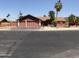 Charming single-story home featuring a two car garage, desert landscaping, and mature palm trees at 8609 S 16Th St, Phoenix, AZ 85042