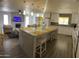 Open kitchen with marble island, white cabinets, and pendant lighting adjacent to the living room at 8609 S 16Th St, Phoenix, AZ 85042