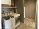 Laundry room area with a washer and dryer, shelving and ample storage at 8609 S 16Th St, Phoenix, AZ 85042