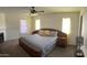 Cozy bedroom featuring a ceiling fan, two windows, and a king-sized bed at 8609 S 16Th St, Phoenix, AZ 85042